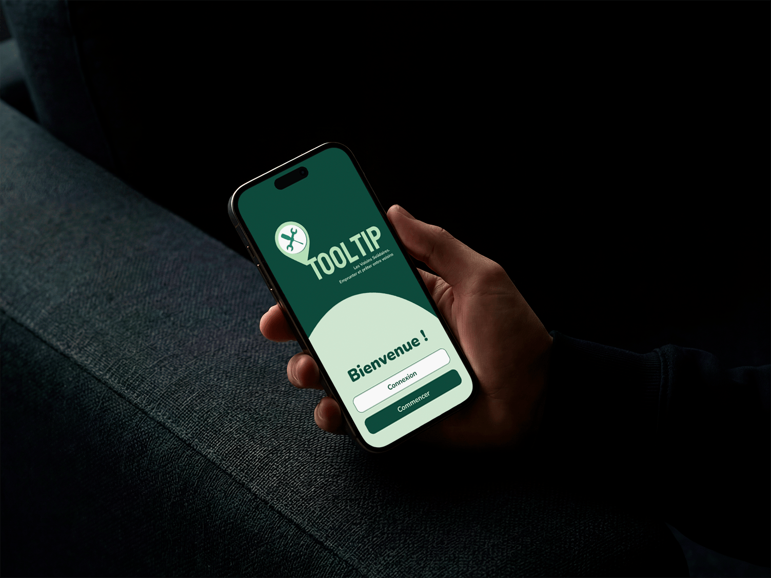 A phone held in one hand, displaying the ToolTip homepage